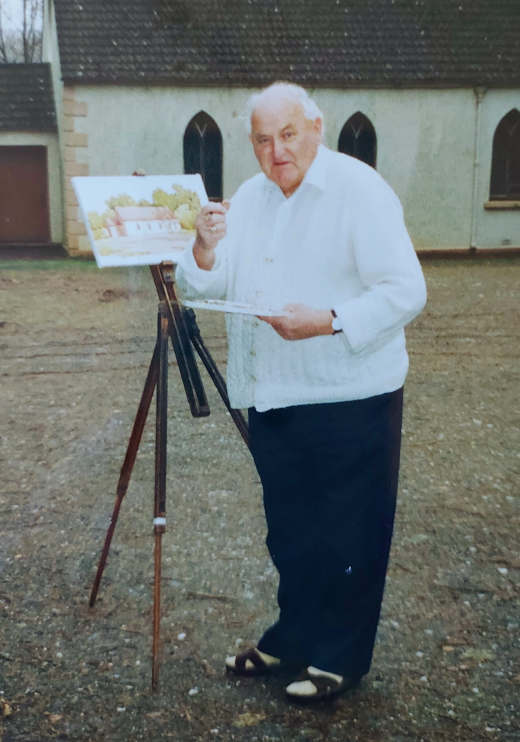 Sam McLarnon painting a picture of the Glenshesk Chapel, 1980's